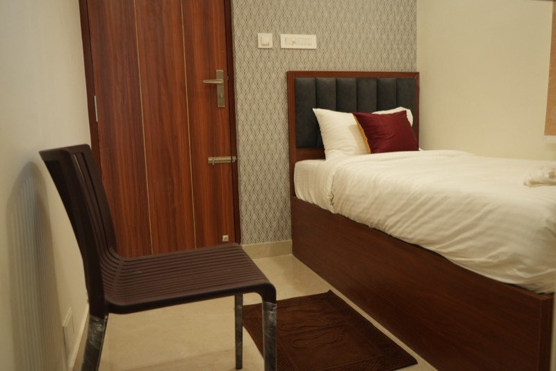 Single bed and chair in the Classic Single Studio