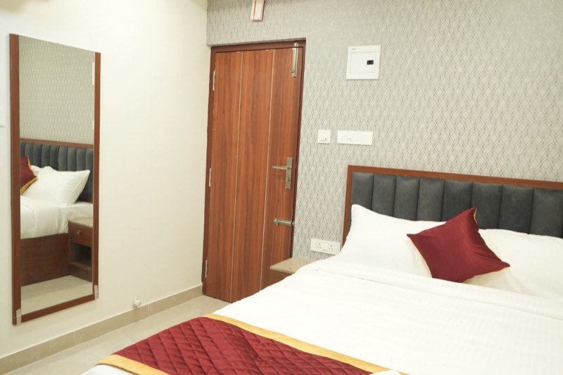Executive Deluxe room with full-length mirror beside the door